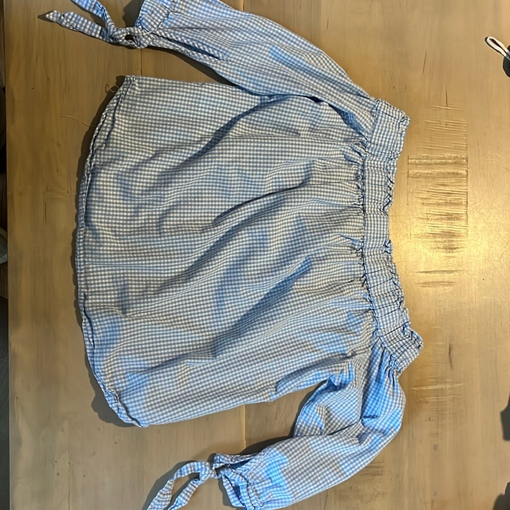 Long sleeve checkered blue top. Off the shoulder. Sleeves tie into bows.